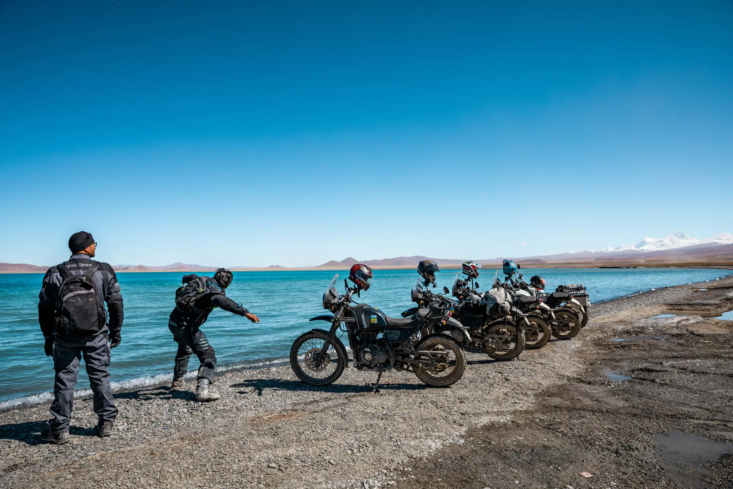 Outdoor scene featuring people, water, and blue sky.