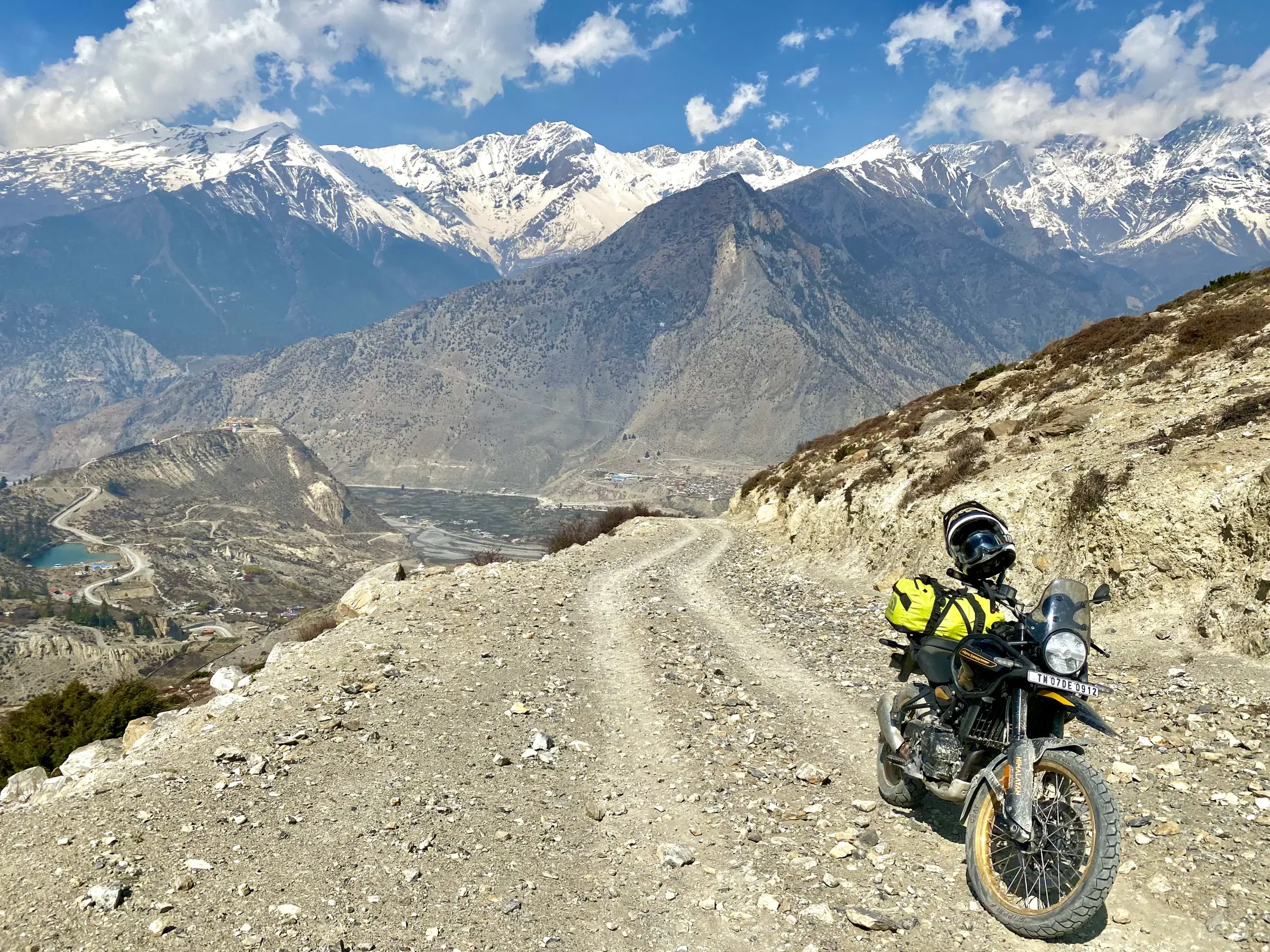 Mountain landscape featuring snowy terrain and cloudy sky.