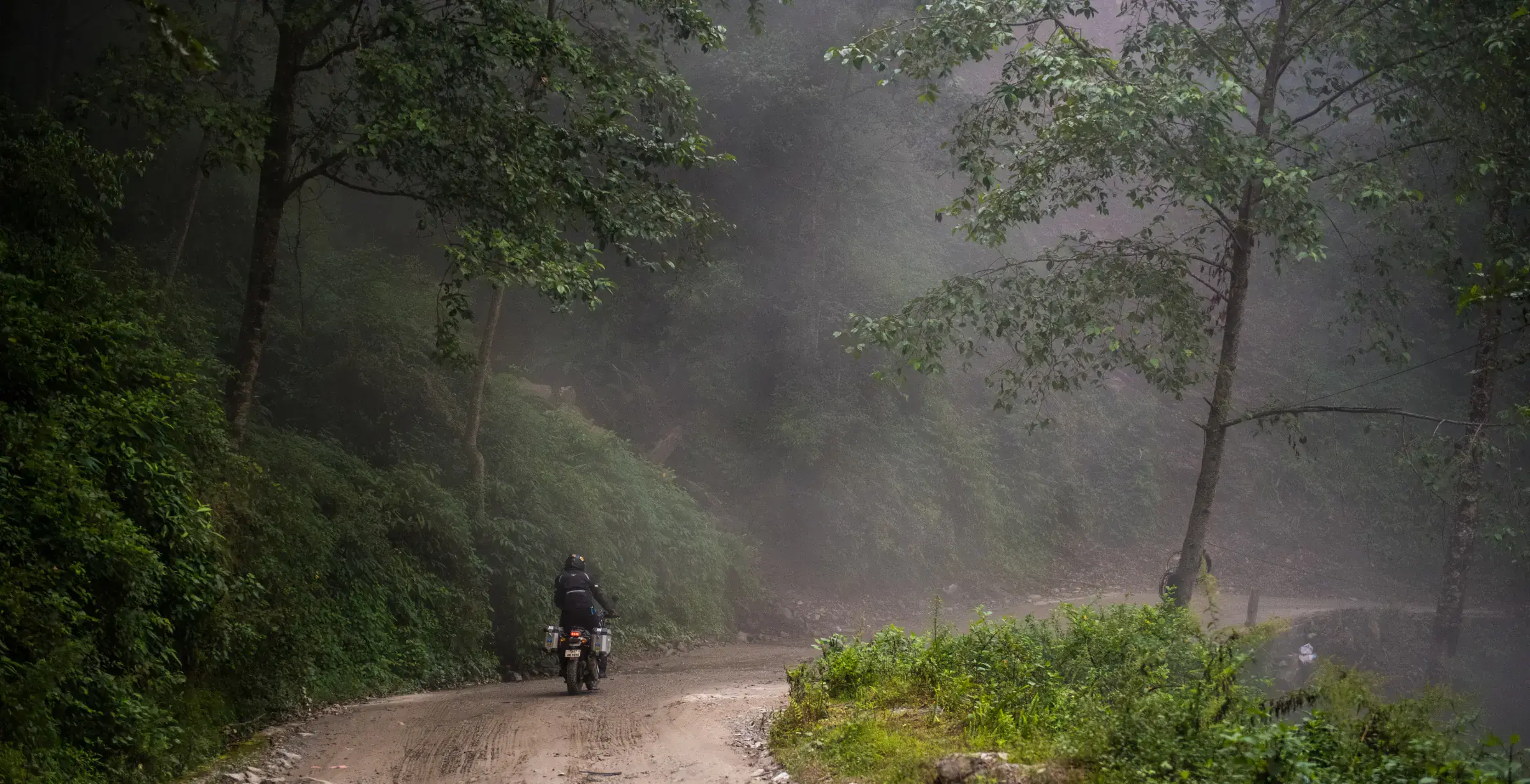 Outdoor scene featuring people, open sky, and greenery.