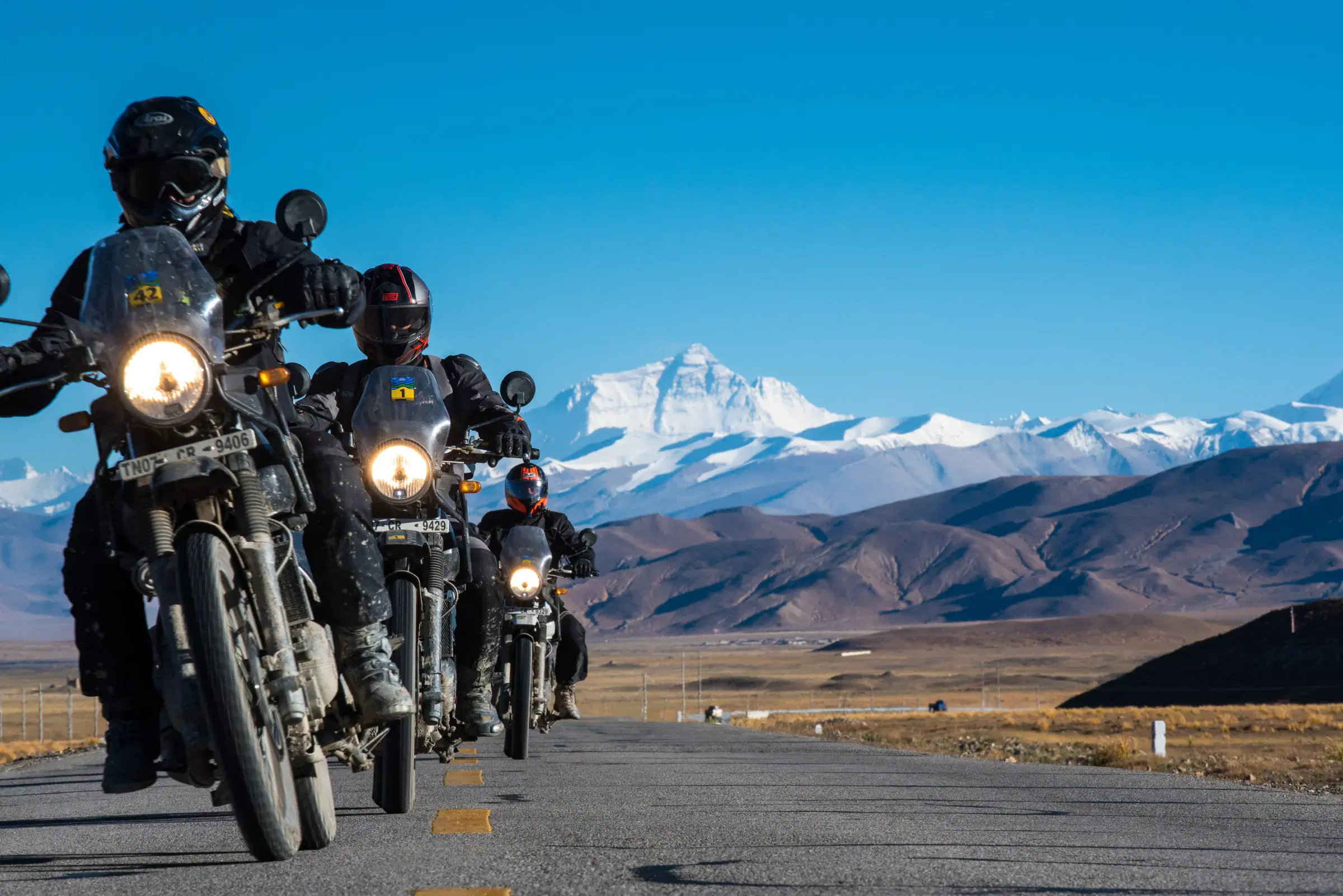 Outdoor scene featuring people, snowy terrain, and blue sky.