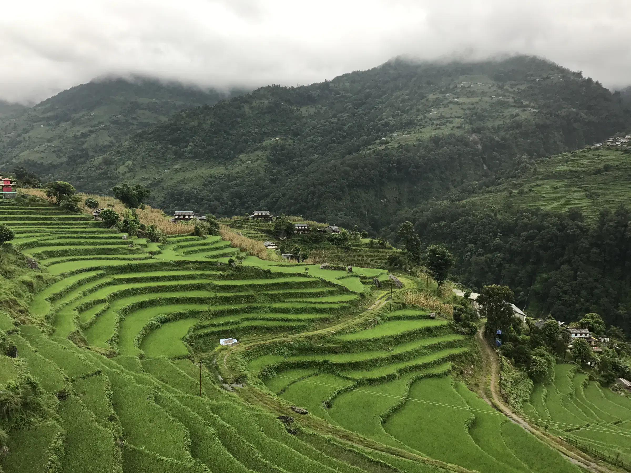 Mountain landscape featuring rocky terrain and cloudy sky.