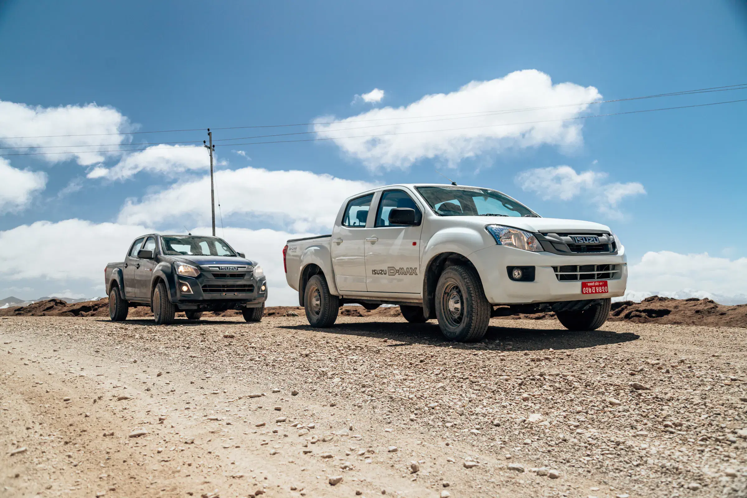 Outdoor vehicle scene featuring a vehicle and cloudy sky.