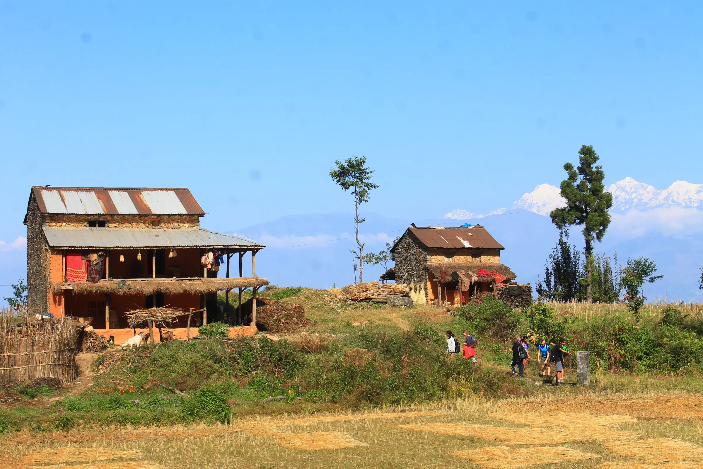 Mountain landscape featuring rocky terrain, cloudy sky, and greenery.