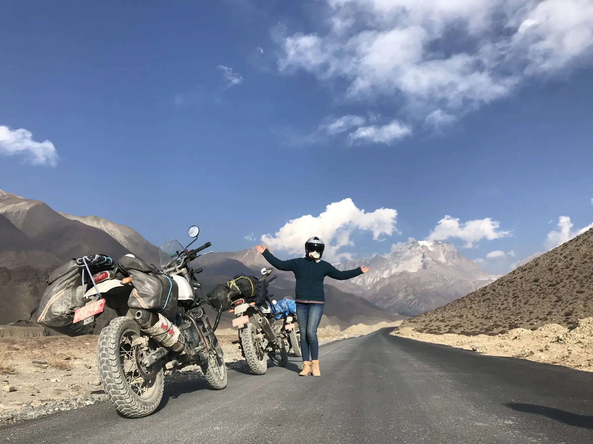 Outdoor adventure scene featuring people, a vehicle, and cloudy sky.