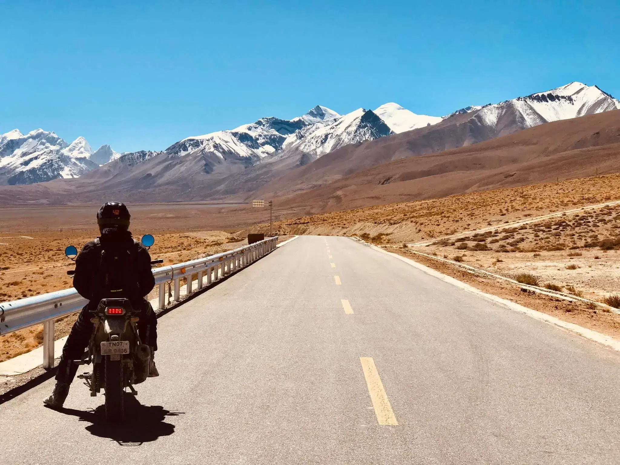 Outdoor scene featuring people, snowy terrain, and blue sky.