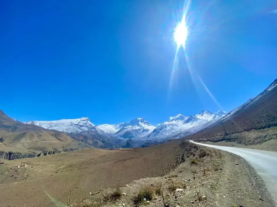 Mountain landscape featuring snowy terrain and blue sky.