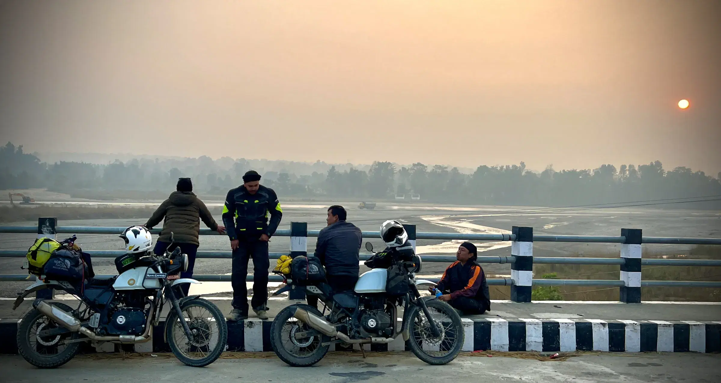 Outdoor adventure scene featuring people, a vehicle, and a built structure.