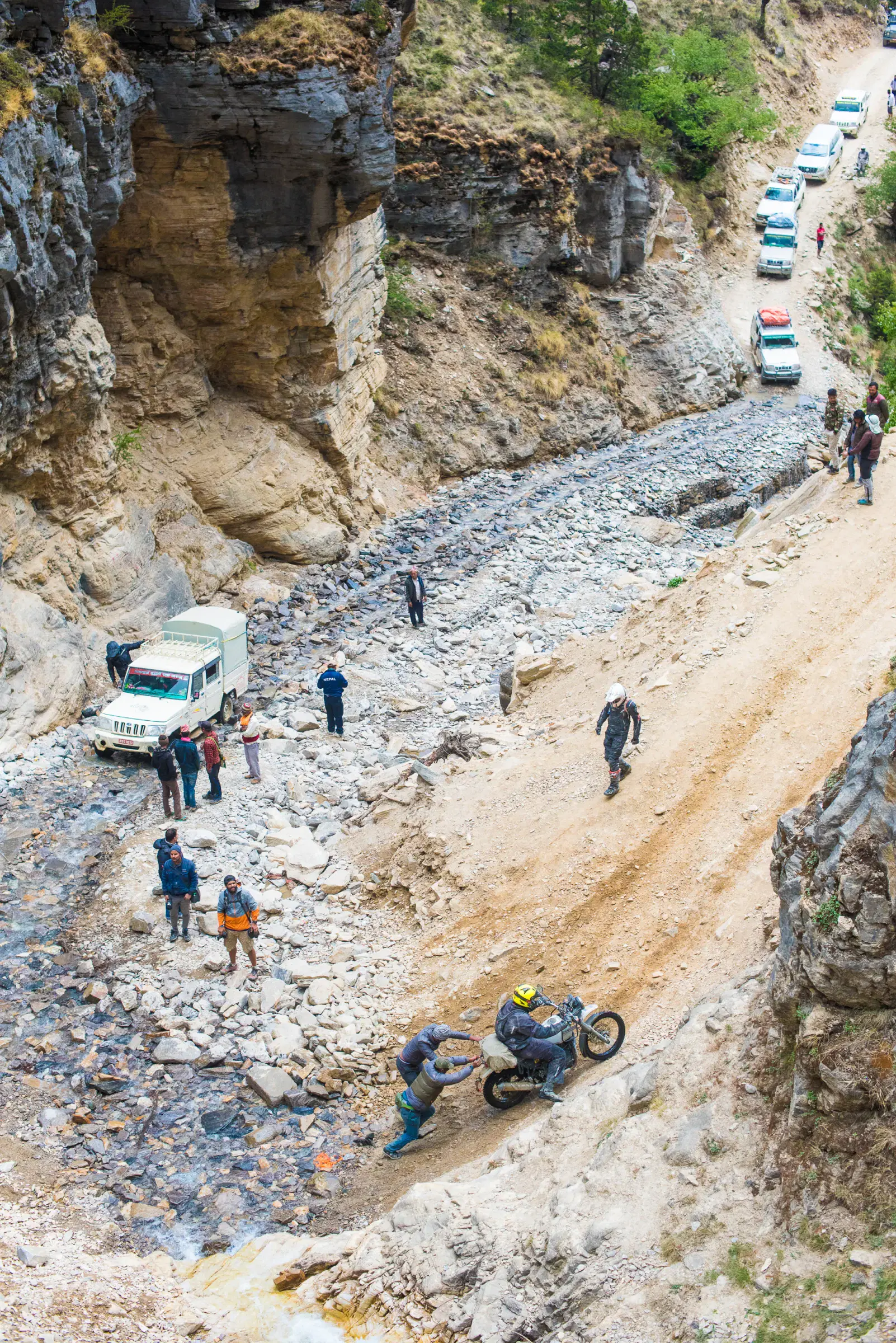 Portrait-oriented Mountain landscape featuring rocky terrain and a built structure.