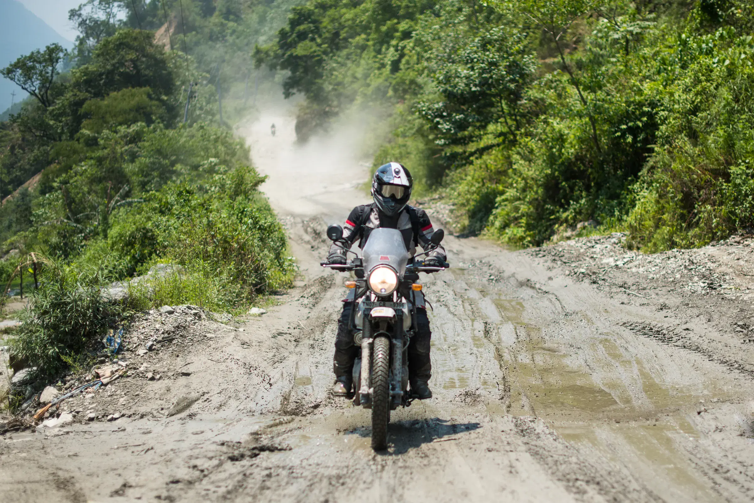 Outdoor adventure scene featuring people and a vehicle.