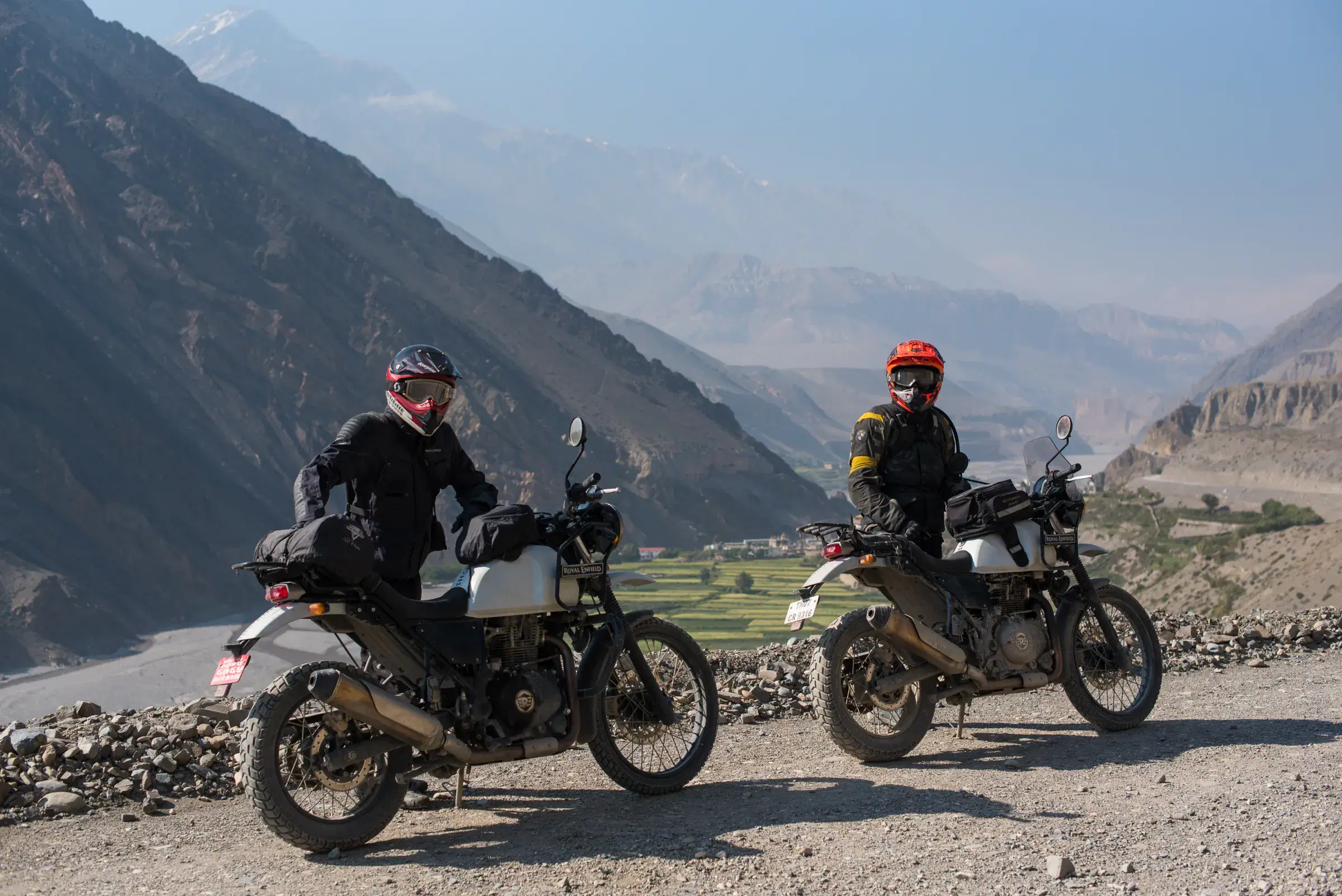 Outdoor scene featuring people, rocky terrain, and blue sky.