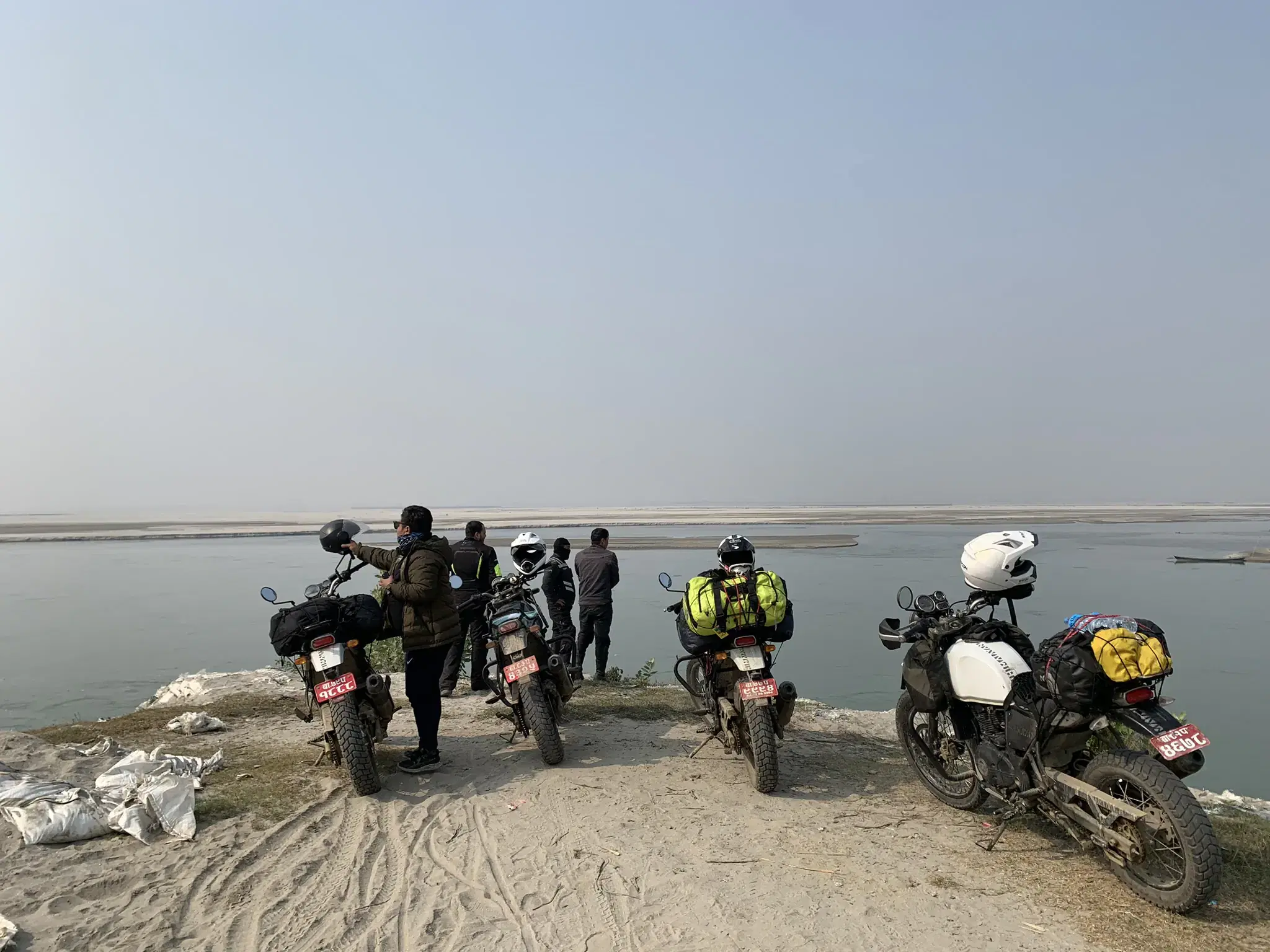 Outdoor adventure scene featuring people, a vehicle, and blue sky.