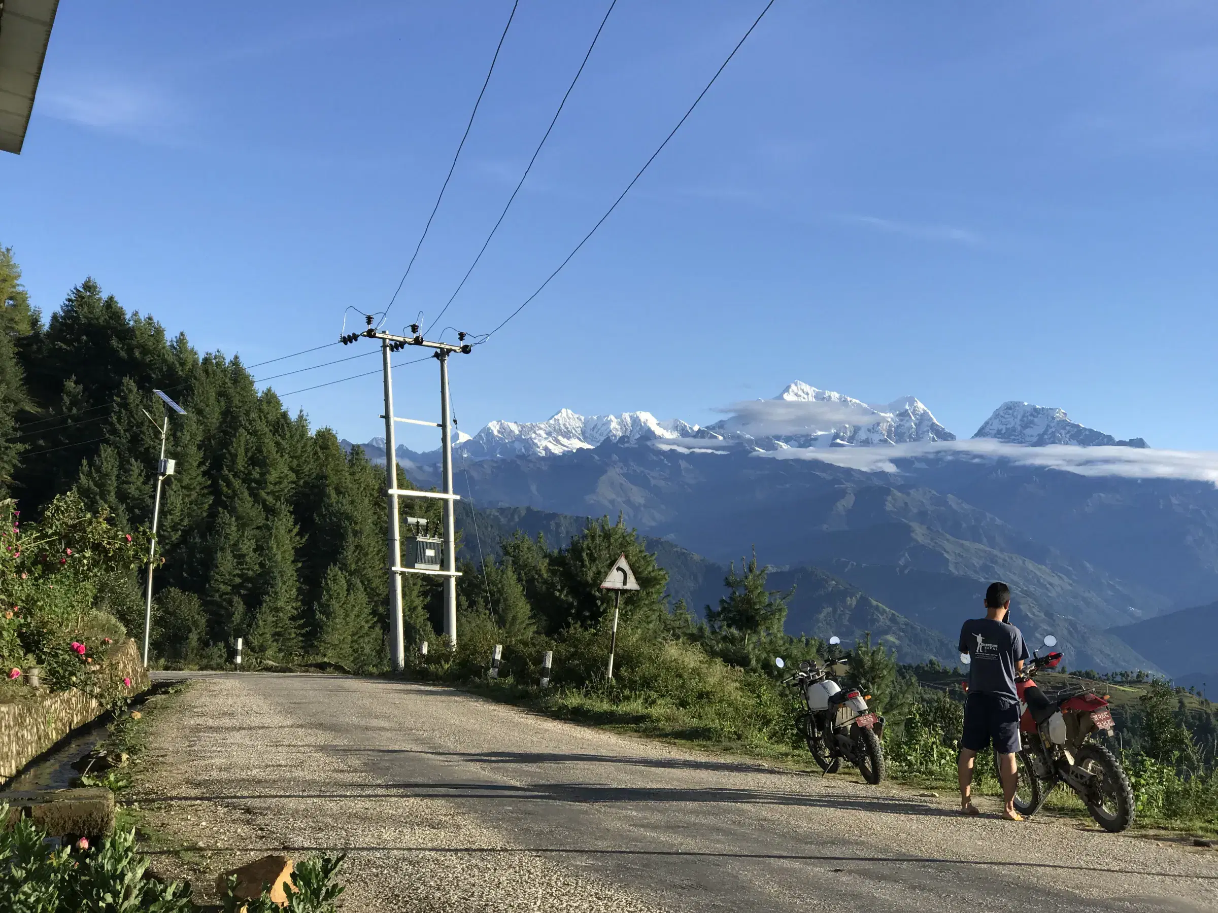 Outdoor scene featuring people, snowy terrain, and blue sky.