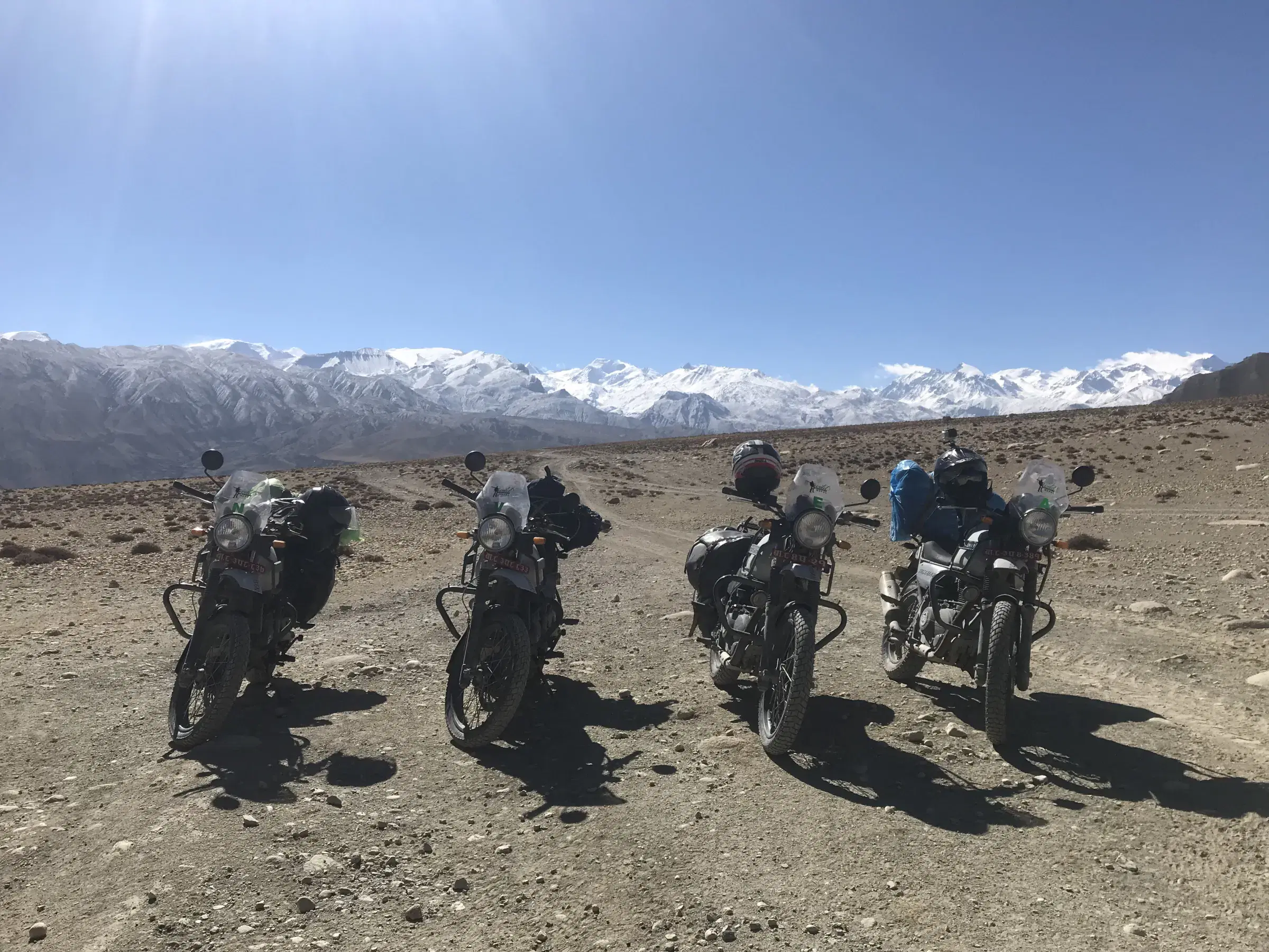 Outdoor scene featuring people, snowy terrain, and cloudy sky.