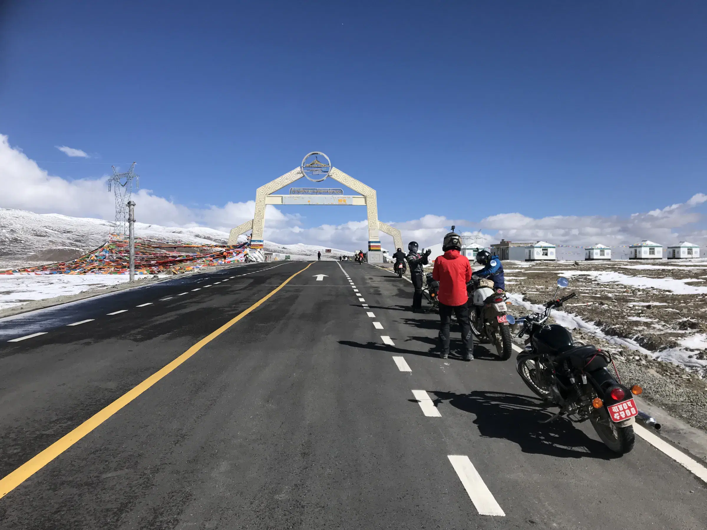 Outdoor scene featuring people, water, and cloudy sky.
