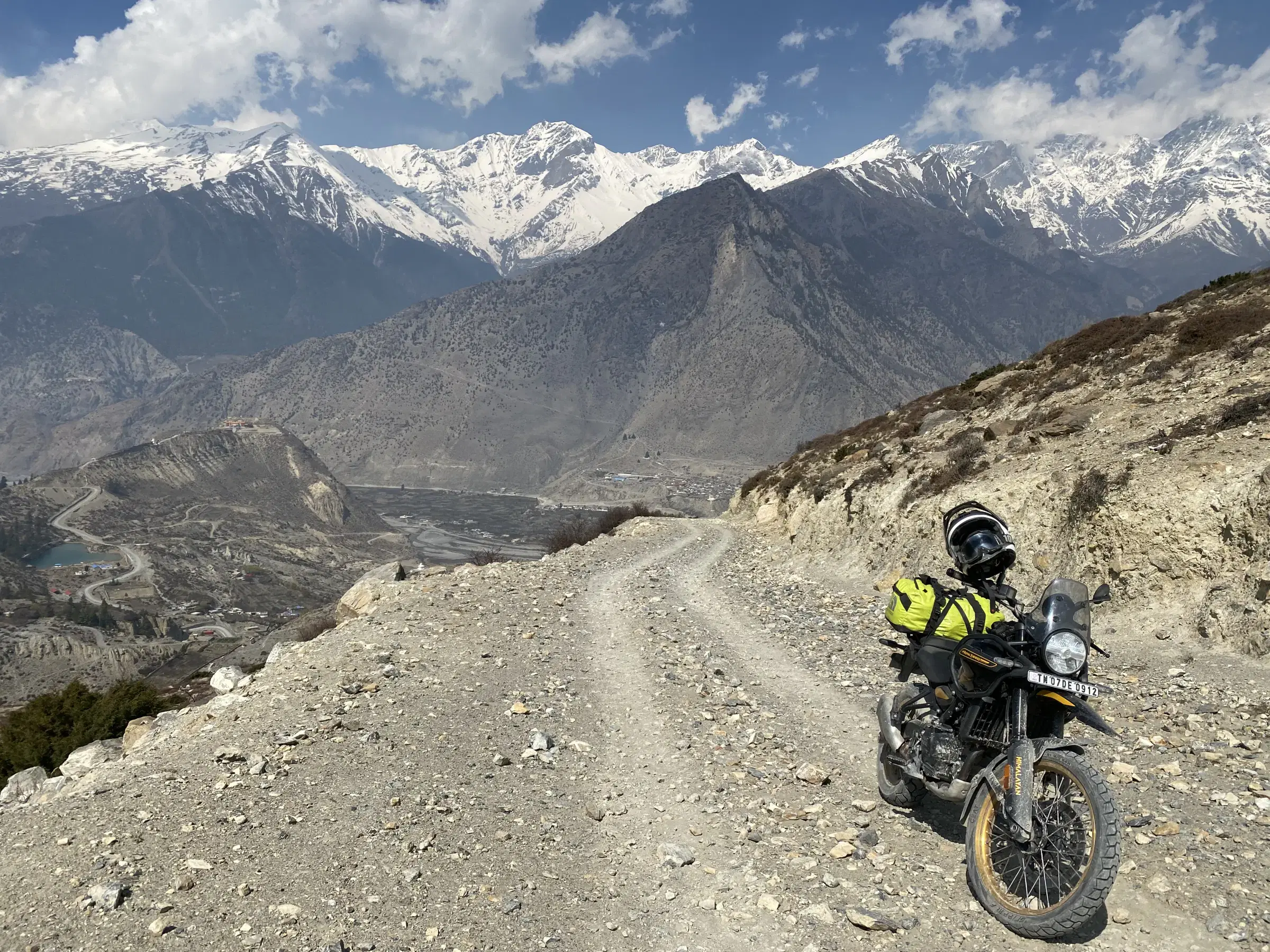 Mountain landscape featuring snowy terrain and cloudy sky.