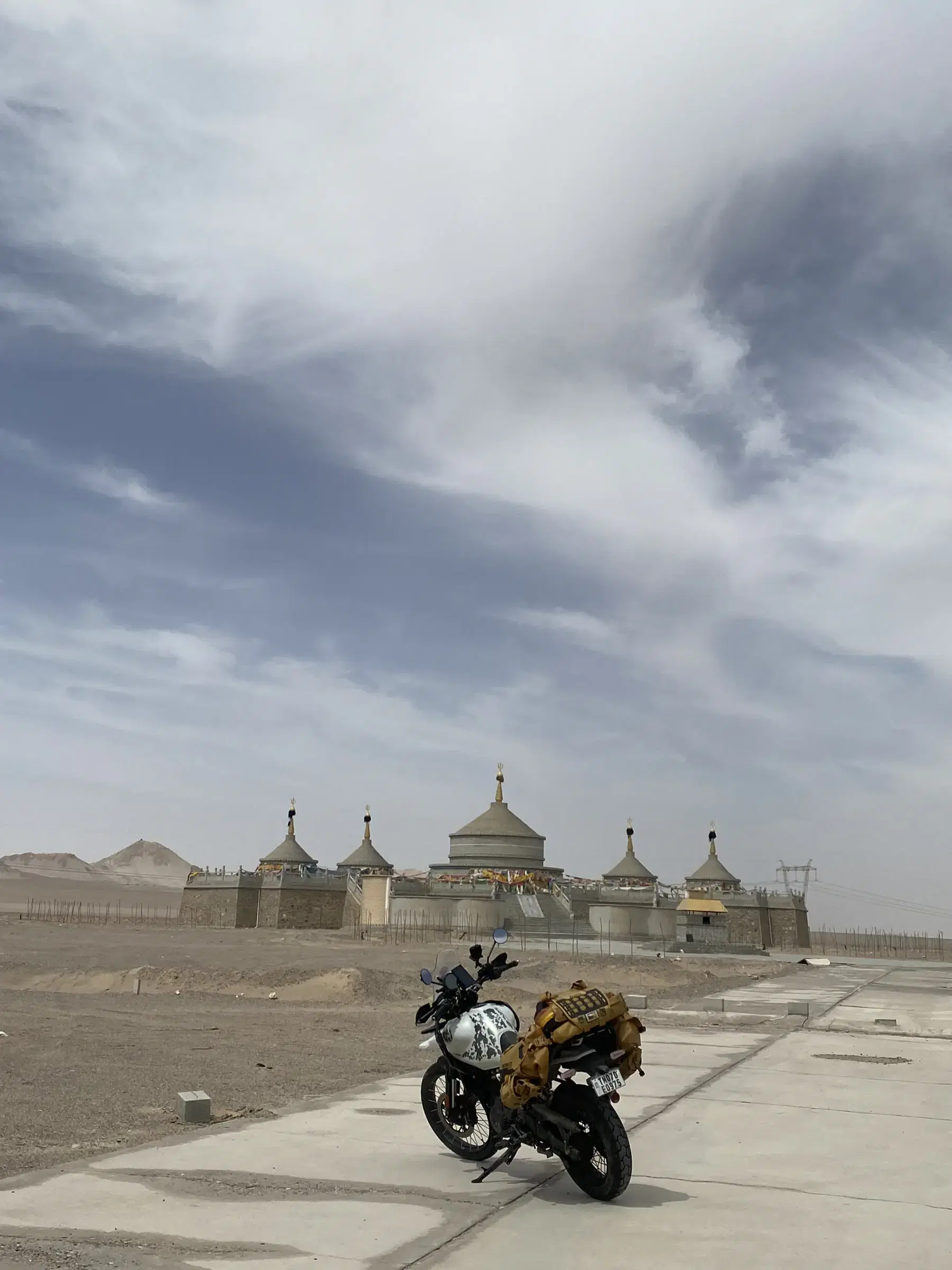 Outdoor adventure scene featuring people, a vehicle, and cloudy sky.