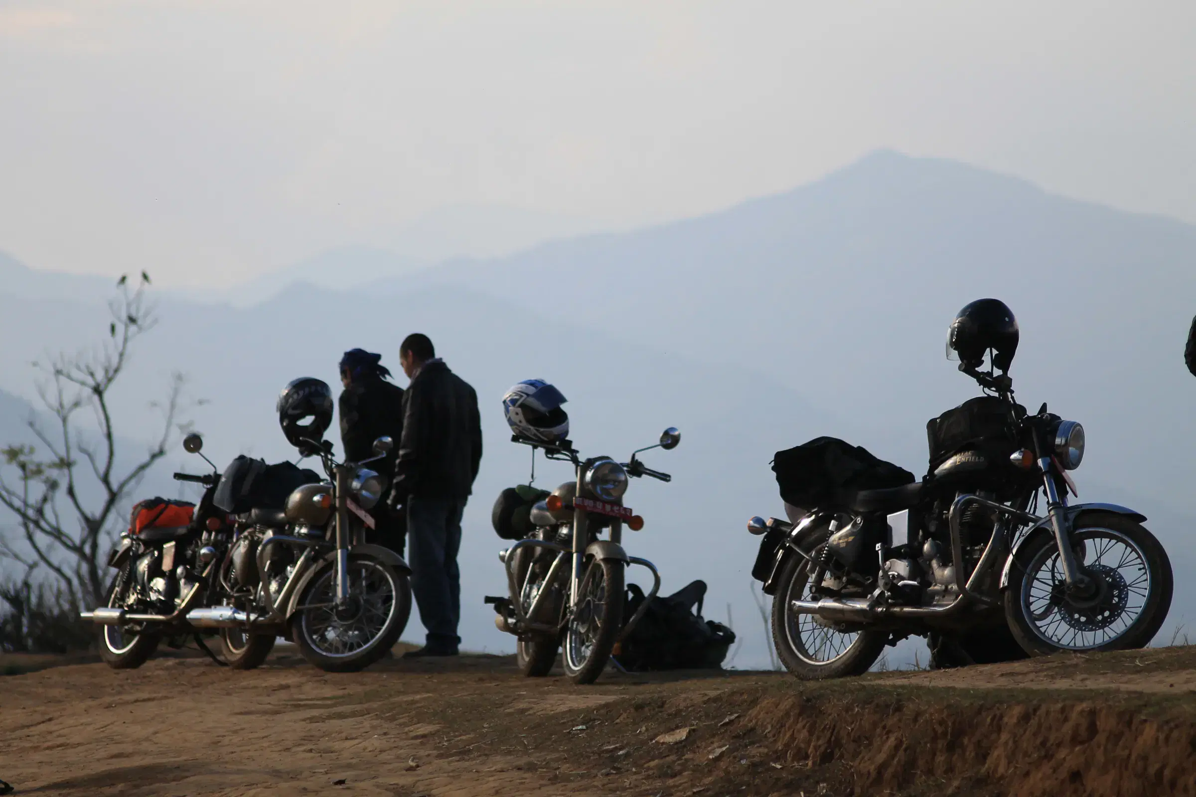 Outdoor adventure scene featuring people, a vehicle, and rocky terrain.