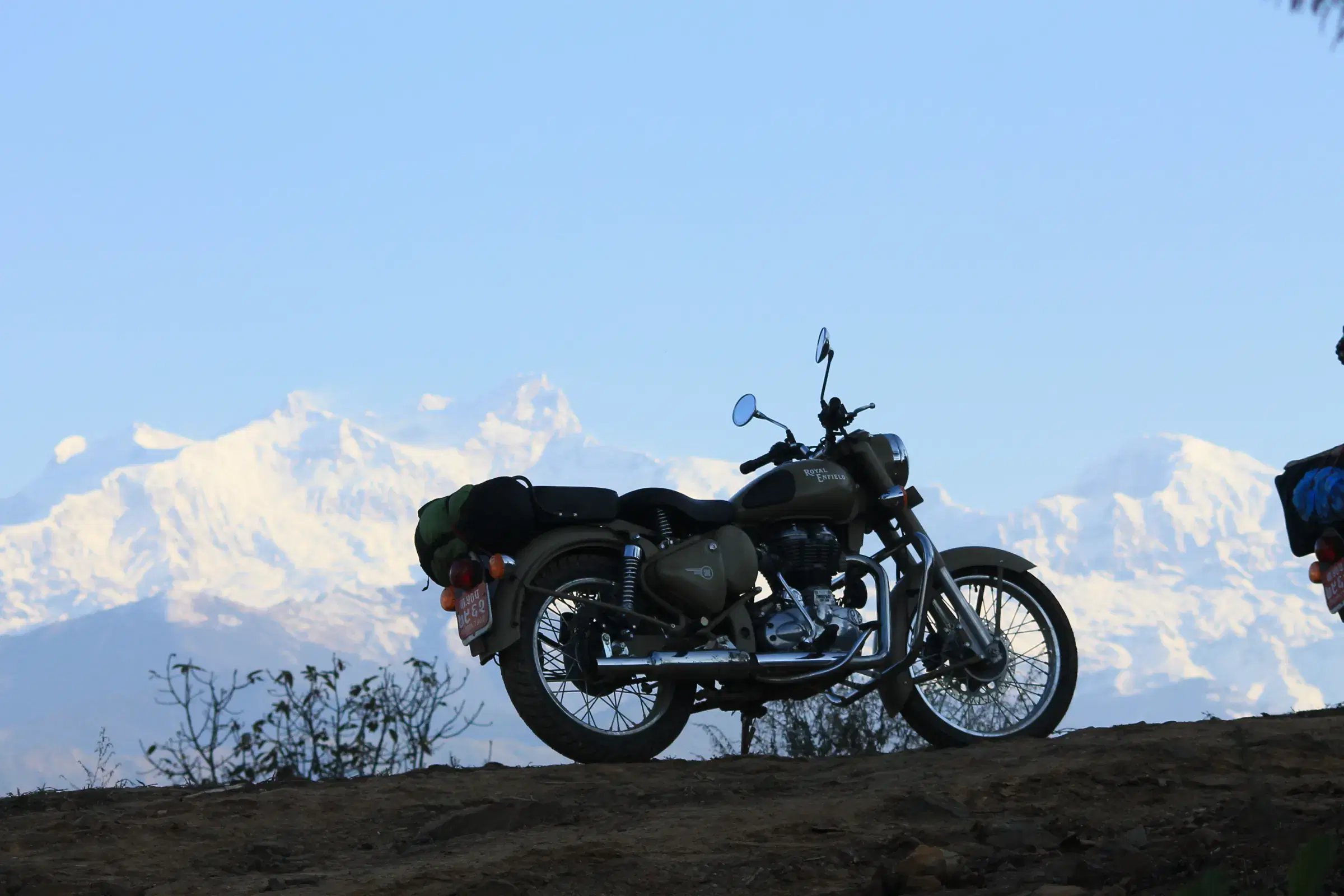 Outdoor scene featuring people, rocky terrain, and cloudy sky.
